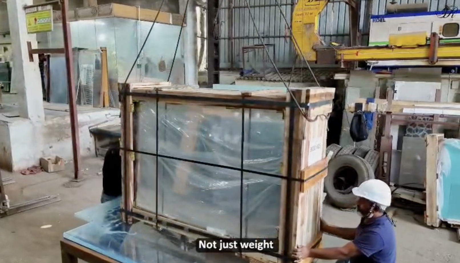 Crated glass panel lifted at the Essar yard